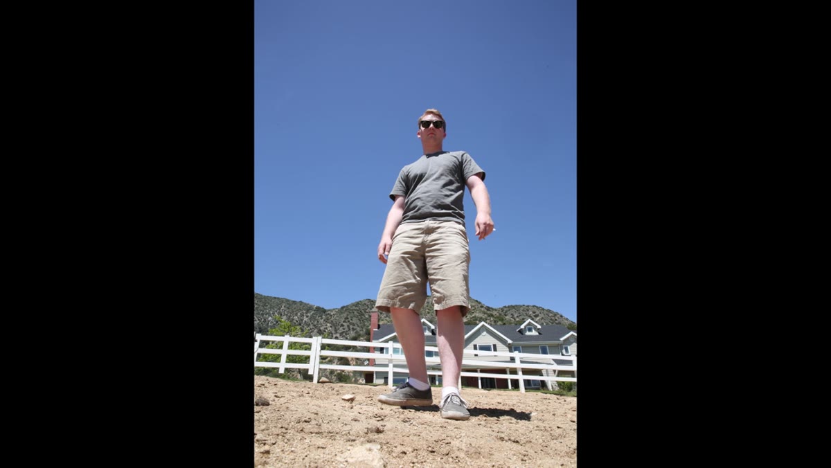 Camera positioned low, subject against blue sky background