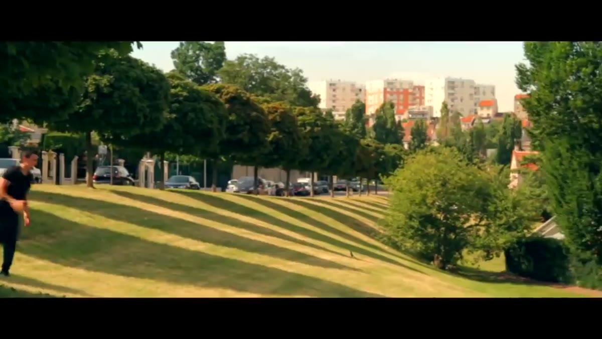 Wide establishing shot of urban environment with subject in motion